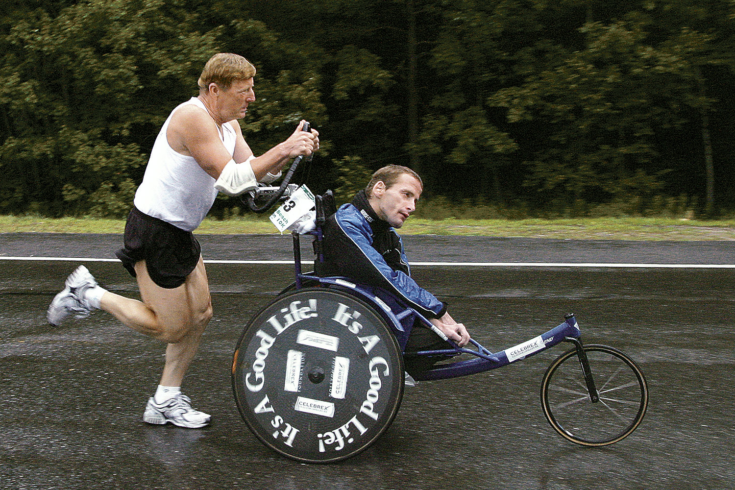 Dick Hoyt pushes his son Rick off from the starting line at the Peoples Beach to Beacon 10K road rac
